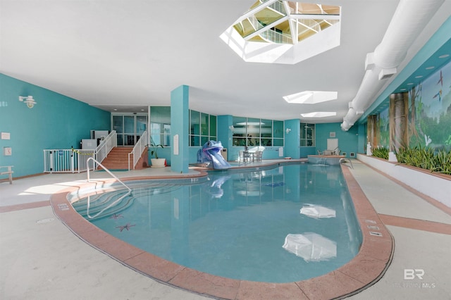 view of pool featuring a skylight