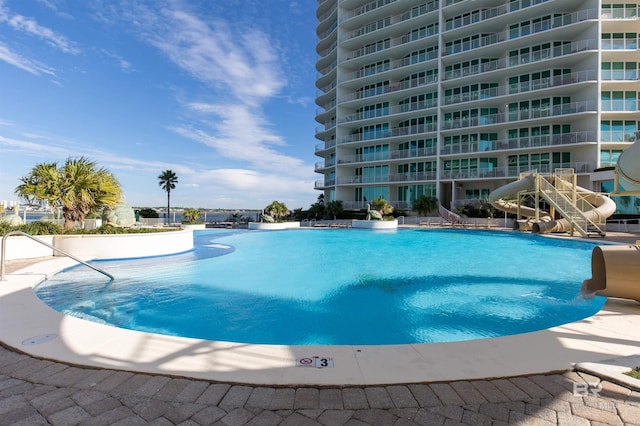 view of swimming pool with a water slide