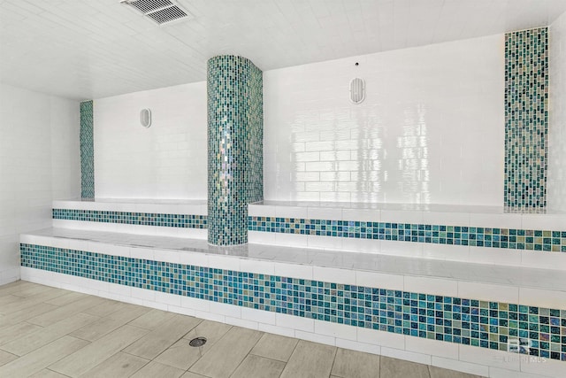 bathroom with tile walls