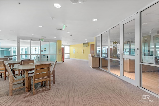 carpeted dining space with plenty of natural light