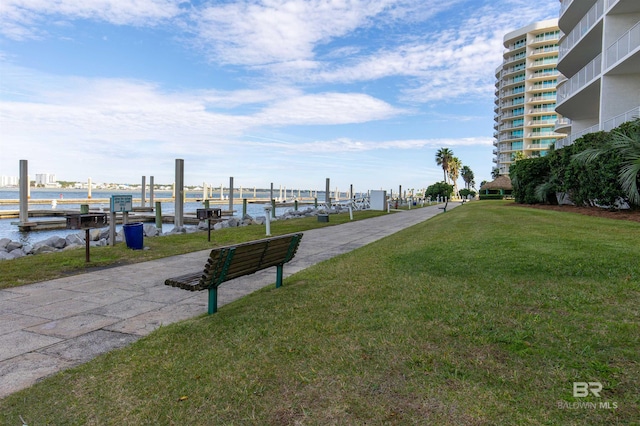 view of property's community featuring a yard and a water view