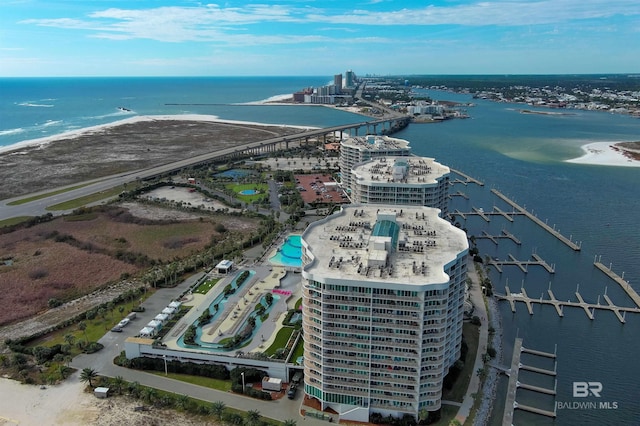 bird's eye view with a water view and a beach view