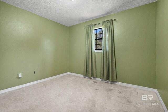 1510 Ponce De Leon Dr, Mobile, AL 36605 - carpeted empty room featuring a textured ceiling and baseboards