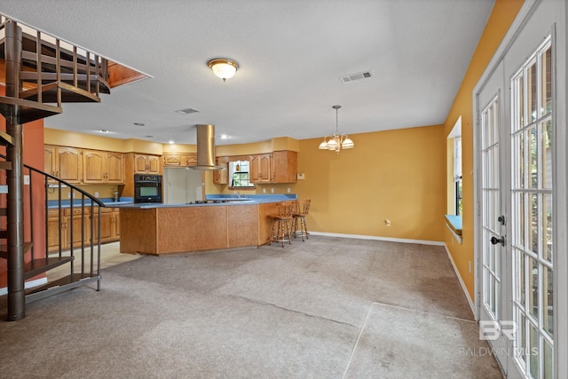 1510 Ponce De Leon Dr, Mobile, AL 36605 - kitchen with oven, island exhaust hood, a peninsula, baseboards, and light carpet