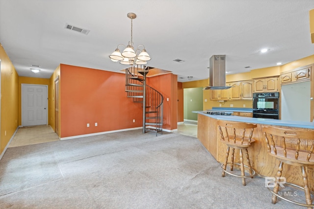 1510 Ponce De Leon Dr, Mobile, AL 36605 - kitchen with island range hood, gas stovetop, light colored carpet, baseboards, and a chandelier
