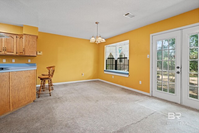 1510 Ponce De Leon Dr, Mobile, AL 36605 - kitchen with a chandelier, french doors, light carpet, and light countertops