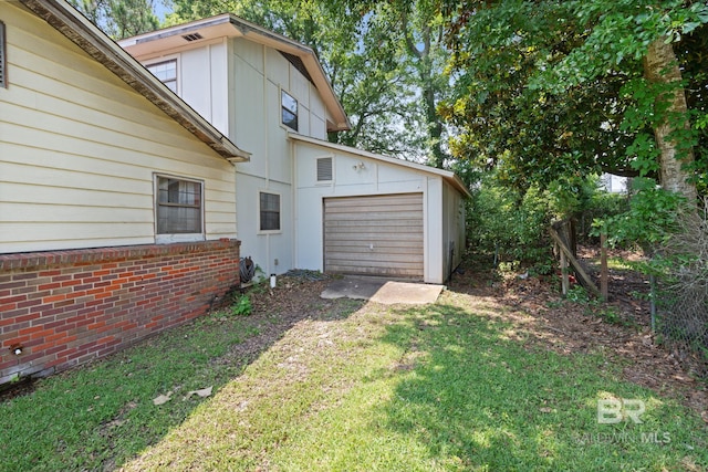 1510 Ponce De Leon Dr, Mobile, AL 36605 - view of side of home with driveway, a garage, a yard, and board and batten siding