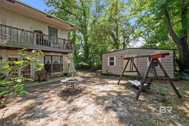 1510 Ponce De Leon Dr, Mobile, AL 36605 - view of yard featuring an outdoor structure and a balcony