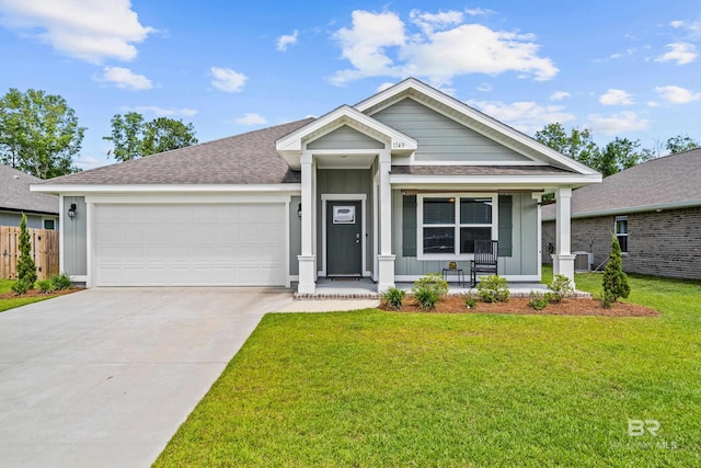 1149 Hayward Loop, Foley, AL 36535 - view of front facade featuring board and batten siding, covered porch, an attached garage, driveway, and a shingled roof