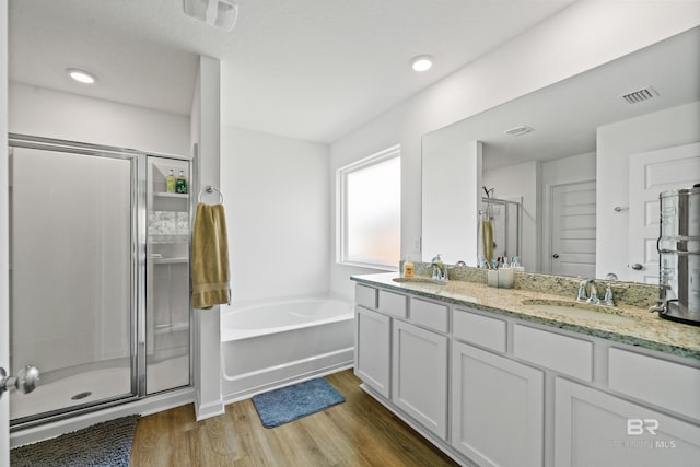 1149 Hayward Loop, Foley, AL 36535 - full bathroom with a shower stall, a garden tub, wood finished floors, double vanity, and recessed lighting