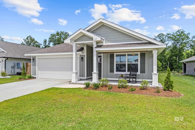 1149 Hayward Loop, Foley, AL 36535 - ranch-style house with board and batten siding, covered porch, a garage, concrete driveway, and a front lawn