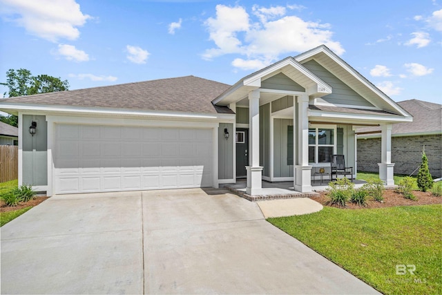 1149 Hayward Loop, Foley, AL 36535 - single story home with a porch, concrete driveway, roof with shingles, and an attached garage