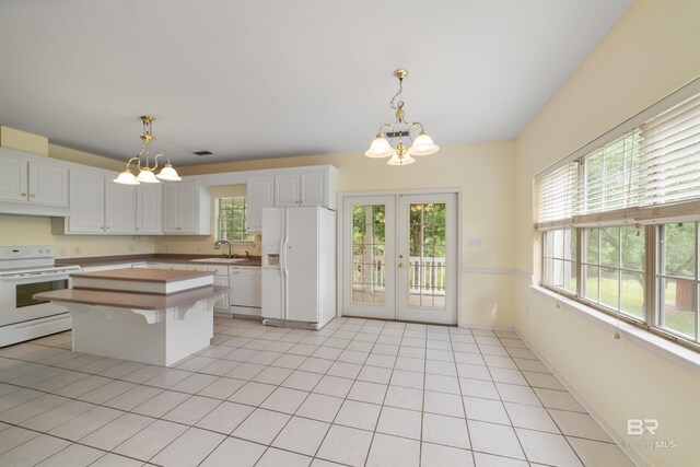 5039 W Cole Dr, Mobile, AL 36619 - kitchen with an inviting chandelier, white cabinets, and white appliances