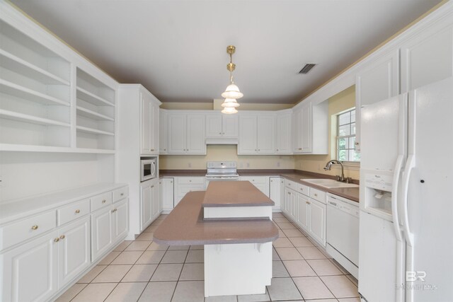 5039 W Cole Dr, Mobile, AL 36619 - kitchen featuring visible vents, open shelves, white appliances, a center island, and a sink