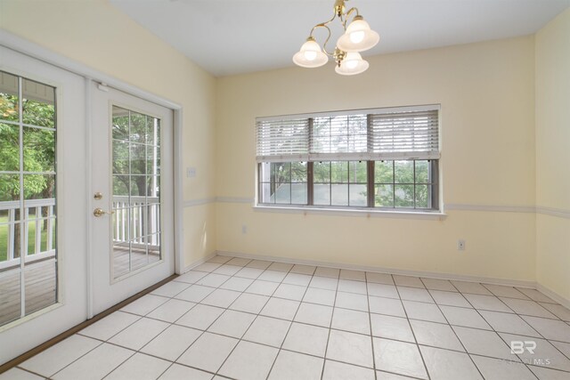 5039 W Cole Dr, Mobile, AL 36619 - unfurnished dining area featuring a healthy amount of sunlight, baseboards, french doors, and a notable chandelier