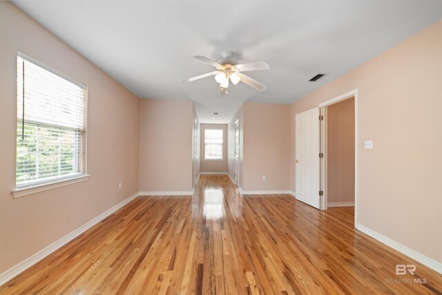 5039 W Cole Dr, Mobile, AL 36619 - spare room with visible vents, light wood finished floors, ceiling fan, and baseboards