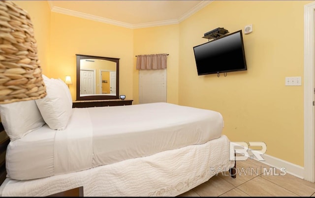 tiled bedroom featuring baseboards and crown molding