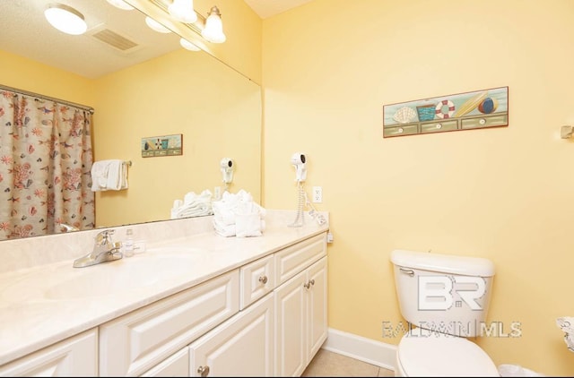 full bathroom featuring vanity, baseboards, visible vents, tile patterned floors, and toilet