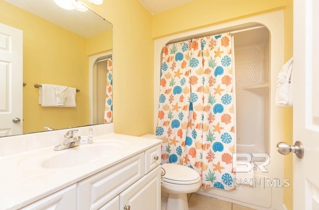 full bathroom featuring vanity, tile patterned floors, and toilet