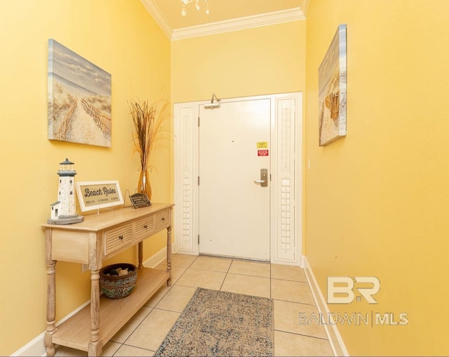 entrance foyer featuring tile patterned floors, baseboards, and ornamental molding
