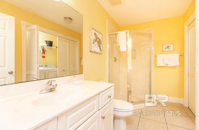 bathroom featuring tile patterned flooring, separate washer and dryer, a closet, and a stall shower