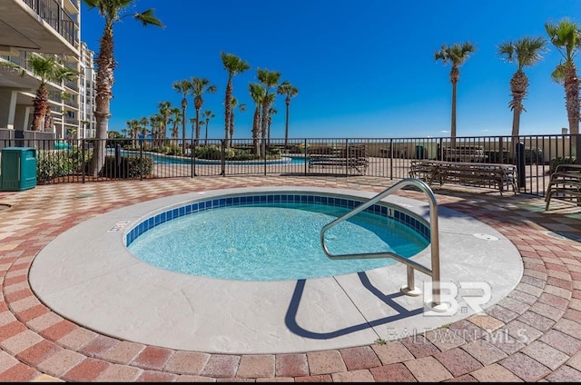view of pool with a patio area and fence