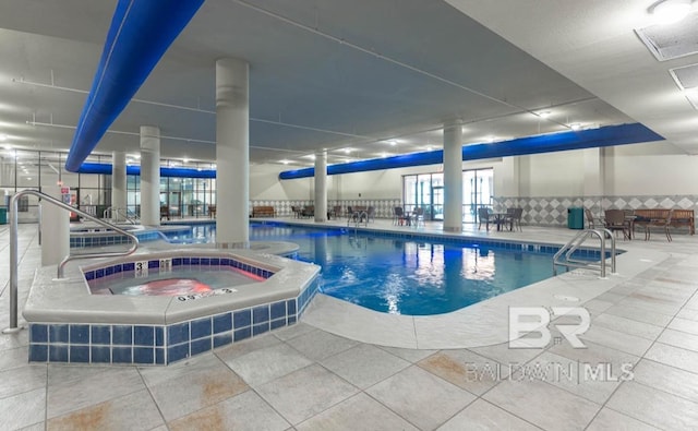 community pool featuring a patio and an indoor hot tub