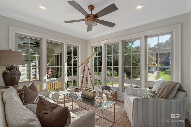 sunroom / solarium featuring ceiling fan