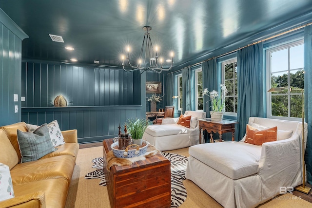 interior space featuring a notable chandelier and wood walls