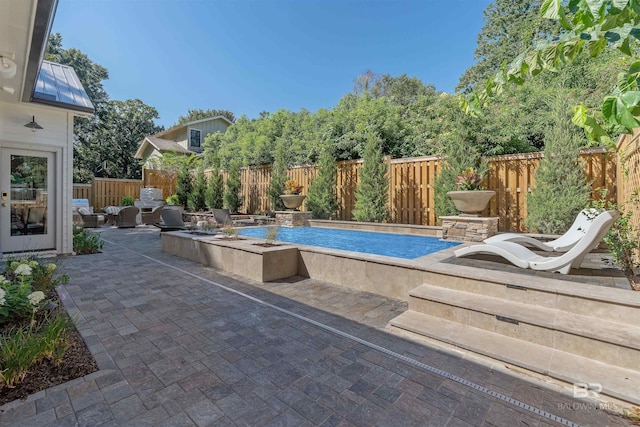 view of swimming pool with a patio area