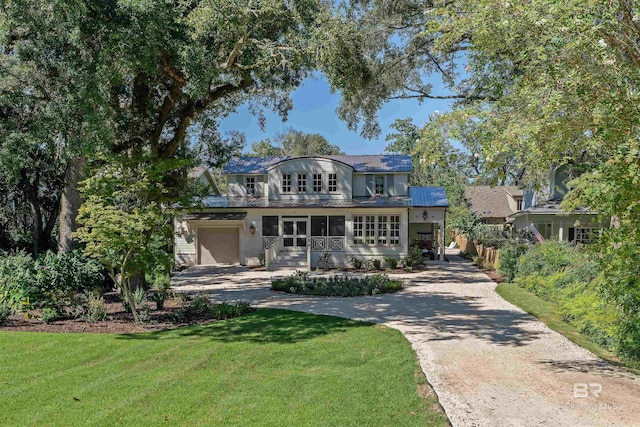 view of front of home with a garage and a front lawn