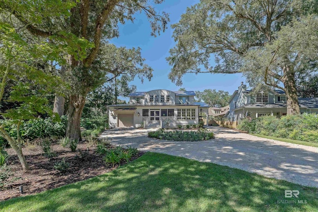 view of front facade with a front lawn and a garage