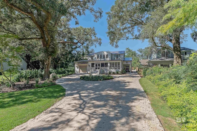 view of front facade with a front lawn and a garage