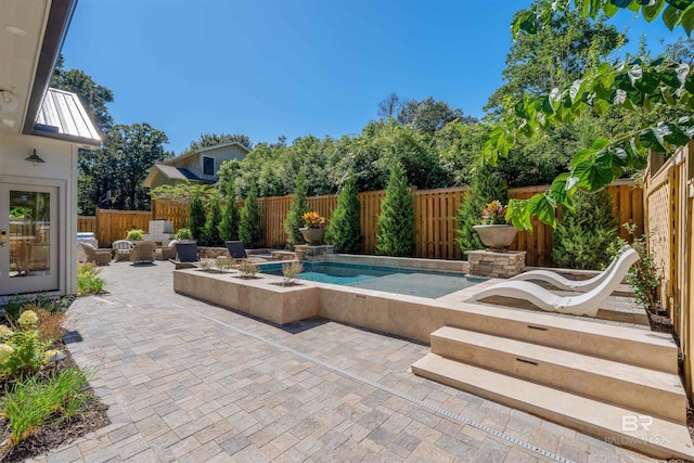 view of pool featuring an in ground hot tub and a patio area