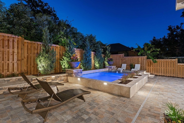 view of swimming pool featuring a patio, pool water feature, and a hot tub