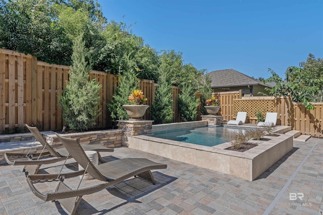 view of swimming pool featuring a patio area