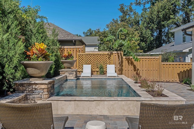 view of swimming pool featuring a patio area