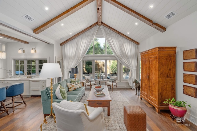 living room featuring beamed ceiling, light hardwood / wood-style flooring, high vaulted ceiling, and wooden ceiling