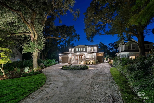 view of front of property featuring a yard and a garage