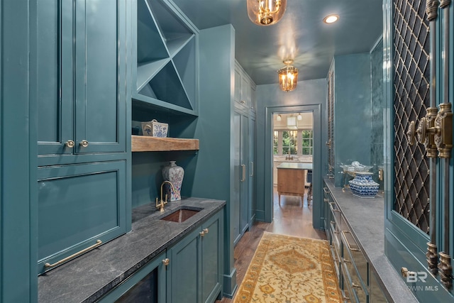 interior space featuring a notable chandelier, hardwood / wood-style floors, and sink