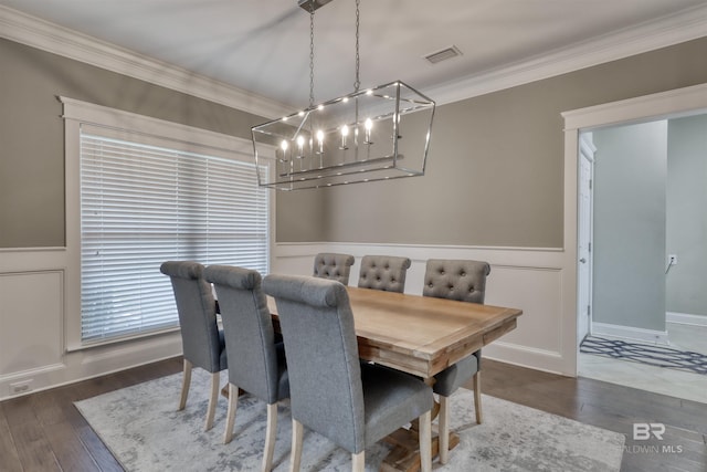 12708 Ibis Blvd, Spanish Fort, AL 36527 - dining area with a chandelier, crown molding, wood finished floors, a wainscoted wall, and a decorative wall