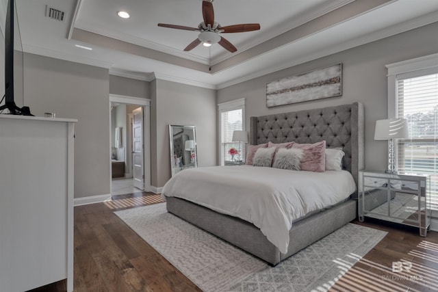 12708 Ibis Blvd, Spanish Fort, AL 36527 - bedroom featuring multiple windows, crown molding, wood finished floors, a tray ceiling, and baseboards