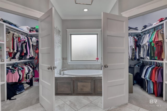 12708 Ibis Blvd, Spanish Fort, AL 36527 - bathroom with a garden tub, a spacious closet, and ornamental molding