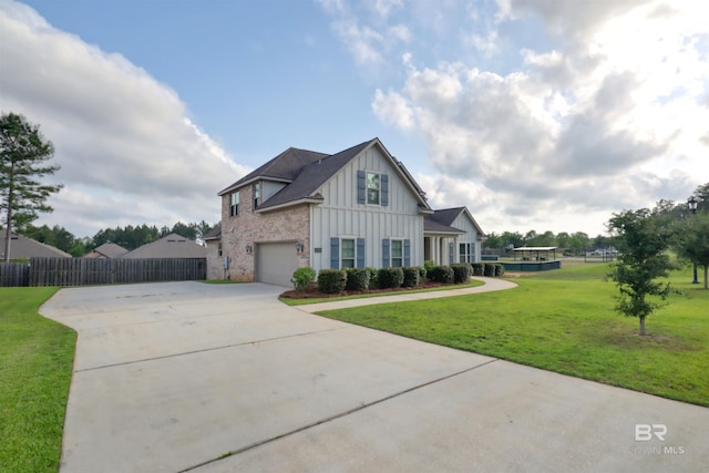 12708 Ibis Blvd, Spanish Fort, AL 36527 - view of front of house featuring board and batten siding, driveway, and a garage