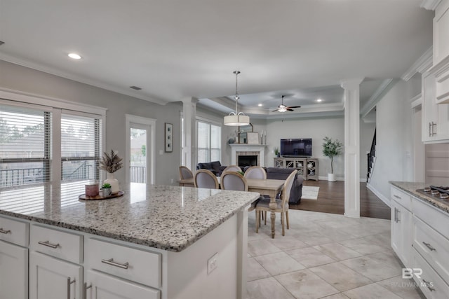 12708 Ibis Blvd, Spanish Fort, AL 36527 - kitchen with decorative columns, a ceiling fan, crown molding, recessed lighting, and a tile fireplace