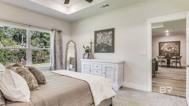 bedroom with light carpet and ceiling fan