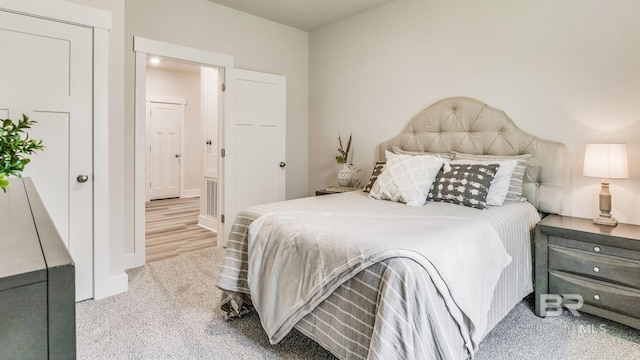 carpeted bedroom with a closet