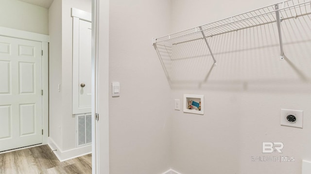 clothes washing area with washer hookup, light hardwood / wood-style flooring, and electric dryer hookup