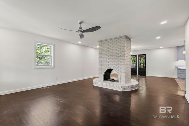 unfurnished living room featuring a ceiling fan, a brick fireplace, wood finished floors, baseboards, and recessed lighting