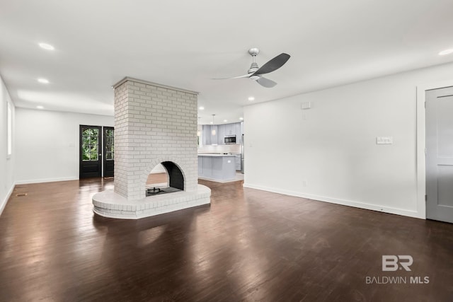 unfurnished living room with a ceiling fan, baseboards, recessed lighting, and dark wood-type flooring
